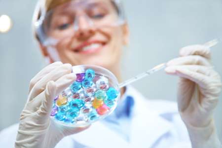 Doctor mixing eggs and sperm in dish