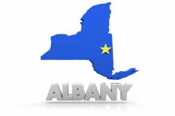 Blue NY State map with gold star on Albany